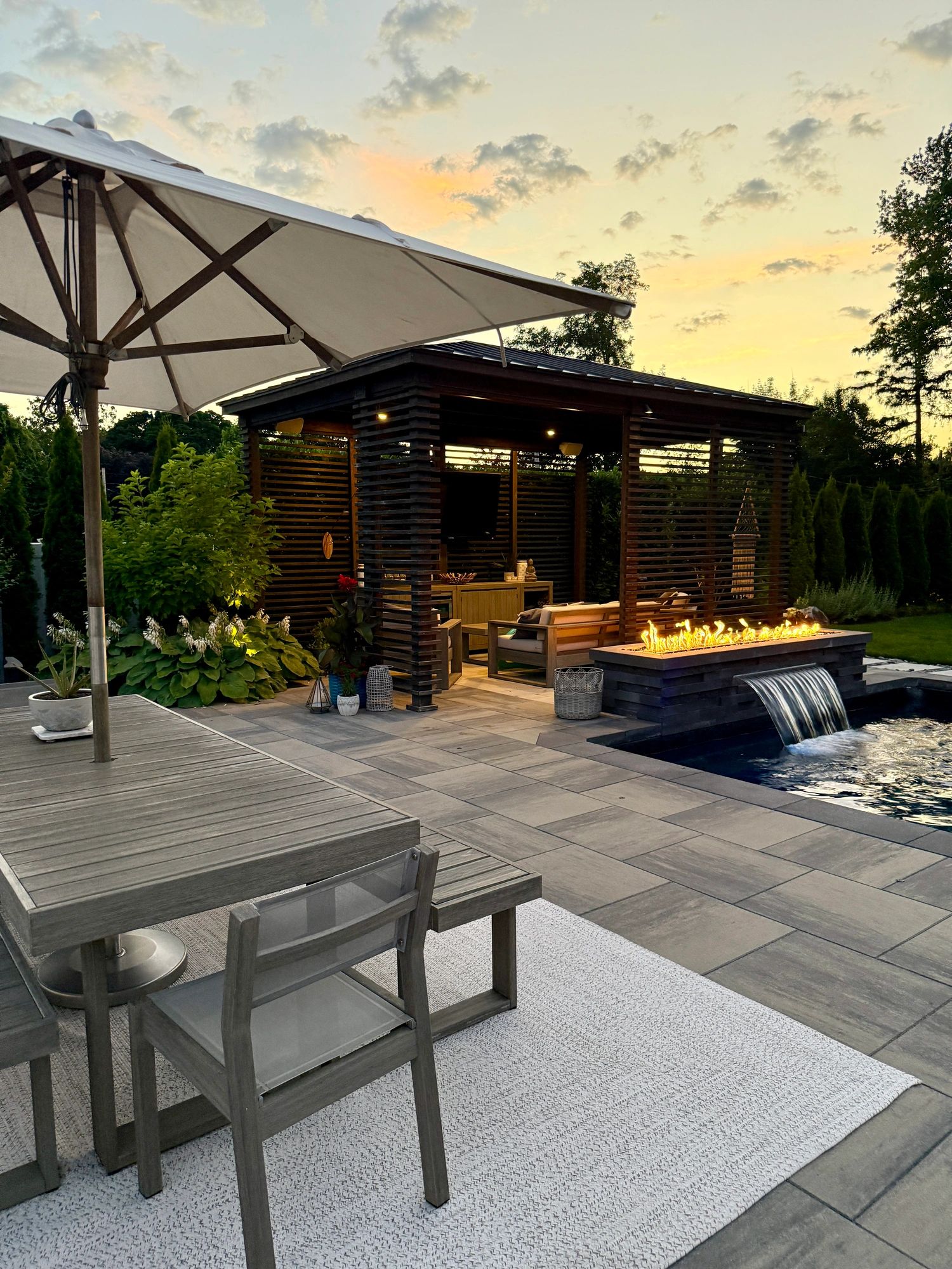 luxury backyard outdoor living modern landscaping pool patio firepit pergola outdoor kitchen